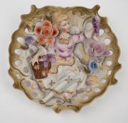 A pair of vintage figural bisque porcelain wall pockets with applied floral decoration, 20th century, ​​​​​​​18cm high. - 2