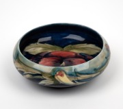 MOORCROFT "Pansy" pottery bowl on green and blue ground impressed "MOORCROFT, MADE IN ENGLAND", 4cm high, 11.5cm diameter.
