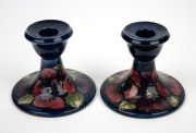 MOORCROFT "Pansy" pair of pottery candlesticks on blue ground impressed "MOORCROFT, MADE IN ENGLAND", 8cm high, 9.5cm diameter. - 2
