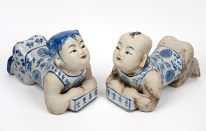 304 · A pair of reproduction Chinese blue and white figural porcelain headrests, 20th century, 22cm high, 32cm long.