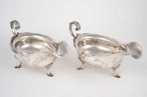 108 · A pair of antique English sterling silver sauce boats, made in Sheffield, circa 1905, ​​​​​​​11cm high, 22cm wide, 690 grams total.