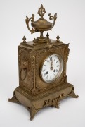 An antique French mantle clock in ornate gilt metal case, with eight day time and bell striking movement and Roman numerals, 19th century, ​​​​​​​36cm high. - 2
