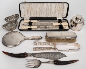 134 · A pair of Continental pierced silver bon bon dishes (80 grams); together with a German 800 silver hand mirror and brush, antique and vintage carving utensils, silver plated tea caddy and silver plated tongs, 19th and 20th century, (qty).