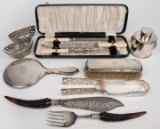 A pair of Continental pierced silver bon bon dishes (80 grams); together with a German 800 silver hand mirror and brush, antique and vintage carving utensils, silver plated tea caddy and silver plated tongs, 19th and 20th century, (qty).