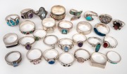Twenty six assorted rings with coloured stones, mostly silver, 130 grams total.