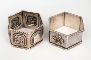 Two antique silver napkin rings, one adorned with cabochon garnets, 19th/20th century, ​​​​​​​60 grams total.
