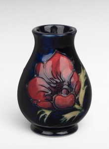 MOORCROFT "Anemone" pottery vase on blue ground, factory mark to base, 10cm high.