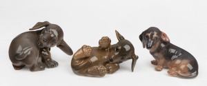 ROYAL COPENHAGEN group of three Danish porcelain dachshund puppy figures, 20th century, factory mark to base, ​​​​​​​the largest 7.5cm high, 10cm long.