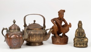 282 · A Tibetan copper teapot, a Balinese holy water pot, a Chinese cast bronze Guanyin statue, and a Balinese wood carving of a cock fighter, mixed vintages, (4 items), the largest 25cm high.