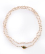 A cultured pearl necklace with 14ct yellow gold clasp, set with an emerald surrounded by diamonds, 20th century, ​​​​​​​92cm long.