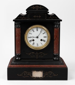An antique French mantle clock in black slate and rouge marble case with eight day time and bell striking movement, bearing silver presentation plaque "Awarded to Mr Hannaford...." and dated 1882, 35cm high.