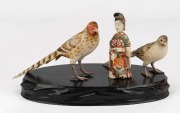 A pair of Chinese carved ivory bird figures with hand-painted finish, together with a carved ivory figural snuff bottle with hand-painted finish, 20th century, ​​​​​​​the bottle 7.5cm high.