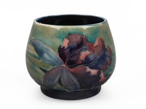 MOORCROFT "Iris" pattern pottery vase on green and blue ground, impressed factory mark to base "Moorcroft, Made In England", 7cm high, 8.5cm diameter.