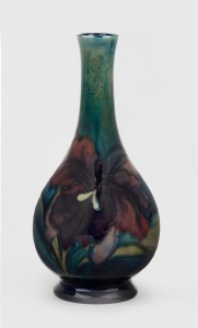 MOORCROFT "Iris" pattern pottery stem vase on green and blue ground, impressed factory to base "Moorcroft, Made In England", 16cm high.