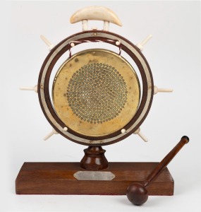 A folk art dinner gong crafted from Australian timbers, whale's tooth, bone and brass, 20th century, ​​​​​​​31cm high.