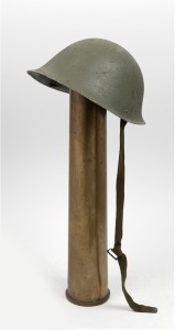 A British MK4 Turtle helmet, circa 1950's, together with an artillery shell, (2 items), ​​​​​​​the shell 63cm high.
