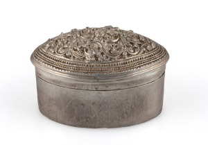 147 · A Burmese silver betel box with floral repousse decoration, 20th century, 5.5cm high, 7.5cm wide, 71 grams total.