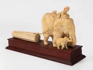 A vintage Burmese carved ivory elephant logging group on timber base, mid 20th century, A/F, 17cm high, 29cm long overall.