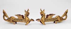 168 · A pair of vintage Burmese carved wooden dragon ornaments with gilt finish and inlaid mirrored decoration, mid 20th century, 22cm high, 48cm long.
