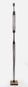 A tall tribal figure, carved wood and trade bead, mounted on later base, African origin, 20th century, ​​​​​​​156cm high overall.