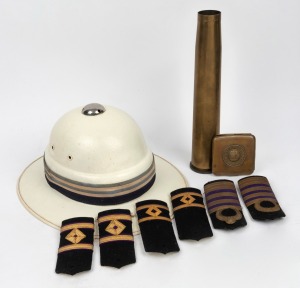 A German WWI period cigarette case, emblazoned with the Imperial crown "GOTT MIT UNS", an artillery shell, three pairs of epaulettes and a vintage police issue pith helmet, 20th century, (qty), ​​​​​​​the artillery shell 31cm high.