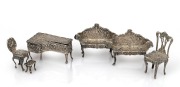 Assorted English sterling silver dolls house furniture, 20th century, ​​​​​​​(note: leg missing on one sofa), the piano 6cm long, 77 grams total.