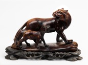 A Chinese carved soapstone tiger and cub statue on carved timber base, early to mid 20th century, 15cm high, 24cm long.