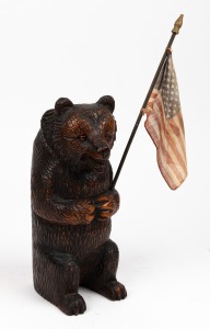 An antique Black Forest carved timber bear statue, with flag, appears to be the base to a possible vase insert, ​​​​​​​24cm high.