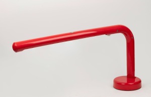A vintage Italian red plastic desk lamp, circa 1970s, 39cm high, 78cm wide,