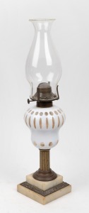An antique oil lamp with white overlay glass font, gilt metal and marble base, plus single burner and glass chimney, 19th century, 49cm high overall.