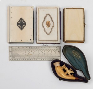 An antique Meerschaum pipe in leather case (mouthpiece damaged), ivory rule, two antique ivory cover books and an ivory card case (split hinge), 19th century, (5 items), ​​​​​​​the rule 15cm long.