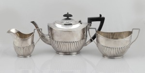 100 · An English sterling silver three piece tea service with ebonized timber handle and finial, made in Sheffield, circa 1908, the largest 16.5cm high, 1018 grams total including handle and finial.