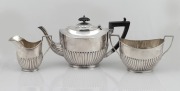 An English sterling silver three piece tea service with ebonized timber handle and finial, made in Sheffield, circa 1908, the largest 16.5cm high, 1018 grams total including handle and finial.