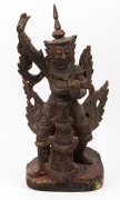 An antique Burmese carved wooden statue of a standing figure with remains of polychrome and gilt finish, 19th/20th century, 51.5cm high.