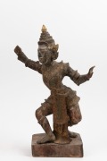An antique Burmese carved wood statue of a dancing figure with remains of polychrome finish, 19th/20th century, A/F, 52cm high.