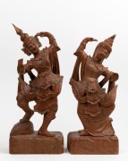 A pair of Burmese carved wooden statues of dancing figures, mid 20th century, 50cm and 47cm high.