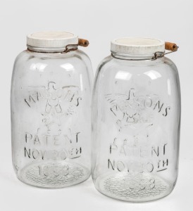 A pair of vintage countertop glass jars, branded "Masons" with embossed eagle motif, 20th century, 41cm high each overall.