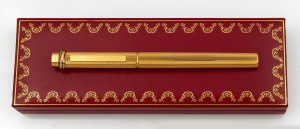 CARTIER "Les Must de Cartier" gold plated ball point pen in original box with folder, card and documentation.