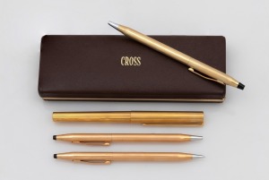Four assorted vintage gold plated pens and pencils.