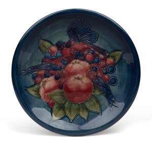 MOORCROFT "Finch and Fruit" pottery platter on blue ground, factory mark to base, 26cm diameter.