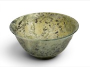 A Chinese spinach jade bowl, 20th century, ​​​​​​​4.5cm high, 10.5cm diameter.