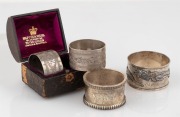 Four antique silver napkin rings, including a Chinese export silver dragon example, and a boxed pair retailed by Mappin & Webb, 19th century, ​​​​​​​100 grams total.