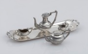 An English sterling silver five piece dolls house tea and coffee service, 20th century, ​​​​​​​15cm wide, 70 grams total.