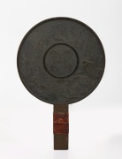 An antique Japanese bronze hand mirror, ​​​​​​​26cm high.