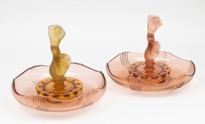 A vintage Art Deco peach glass float bowl with figural finial; together with a two tone amber and peach glass float bowl with figural finial, mid 20th century, (2 items), 30cm wide.