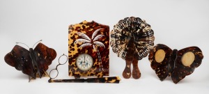 Assorted tortoiseshell and celluloid items comprising of a fan, lorgnette, butterfly ornament, butterfly picture frame and clock, mixed vintages, 19th/20th century, (5 items), ​​​​​​​the largest 22cm high.