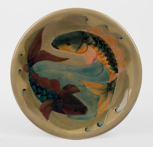 MOORCROFT "Fish" pattern pottery charger on celadon green ground, impressed signature mark to base "Moorcroft, Made In England, W.M.", 35cm diameter.