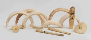 An attractive antique Japanese carved ivory parasol handle, two carved ivory cigarette holders, two carved ivory miniature parasols, and a group of assorted boar tusks, 19th/20th century, the handle 10cm high.