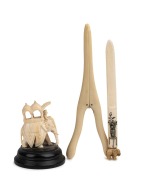 An antique Japanese ivory Shibayama letter opener, an Indian carved ivory elephant ornament and an ivory glove stretcher, 19th/20th century, (3 items), ​​​​​​​the largest 16cm long.