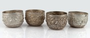 Four Burmese silver tea bowls, 20th century, 5cm high, 7cm diameter, 198 grams total.
